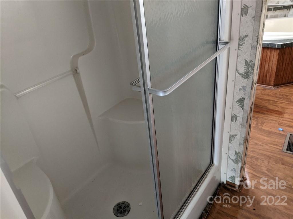 1449 State Rd S-28-313 Cassatt, SC 29032 - Photo 8 of 13 a bathroom with a shower and a mirror