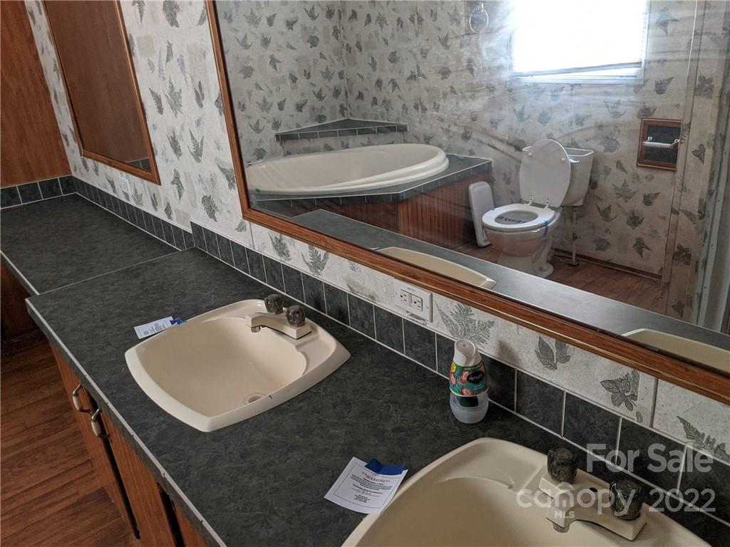 1449 State Rd S-28-313 Cassatt, SC 29032 - Photo 9 of 13 a bathroom with a sink and a mirror