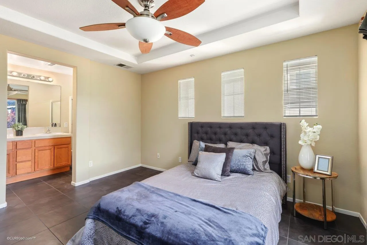 1685 Avery Road San Marcos, CA 92078 - Photo 15 of 26 a bedroom with a large bed and a chandelier