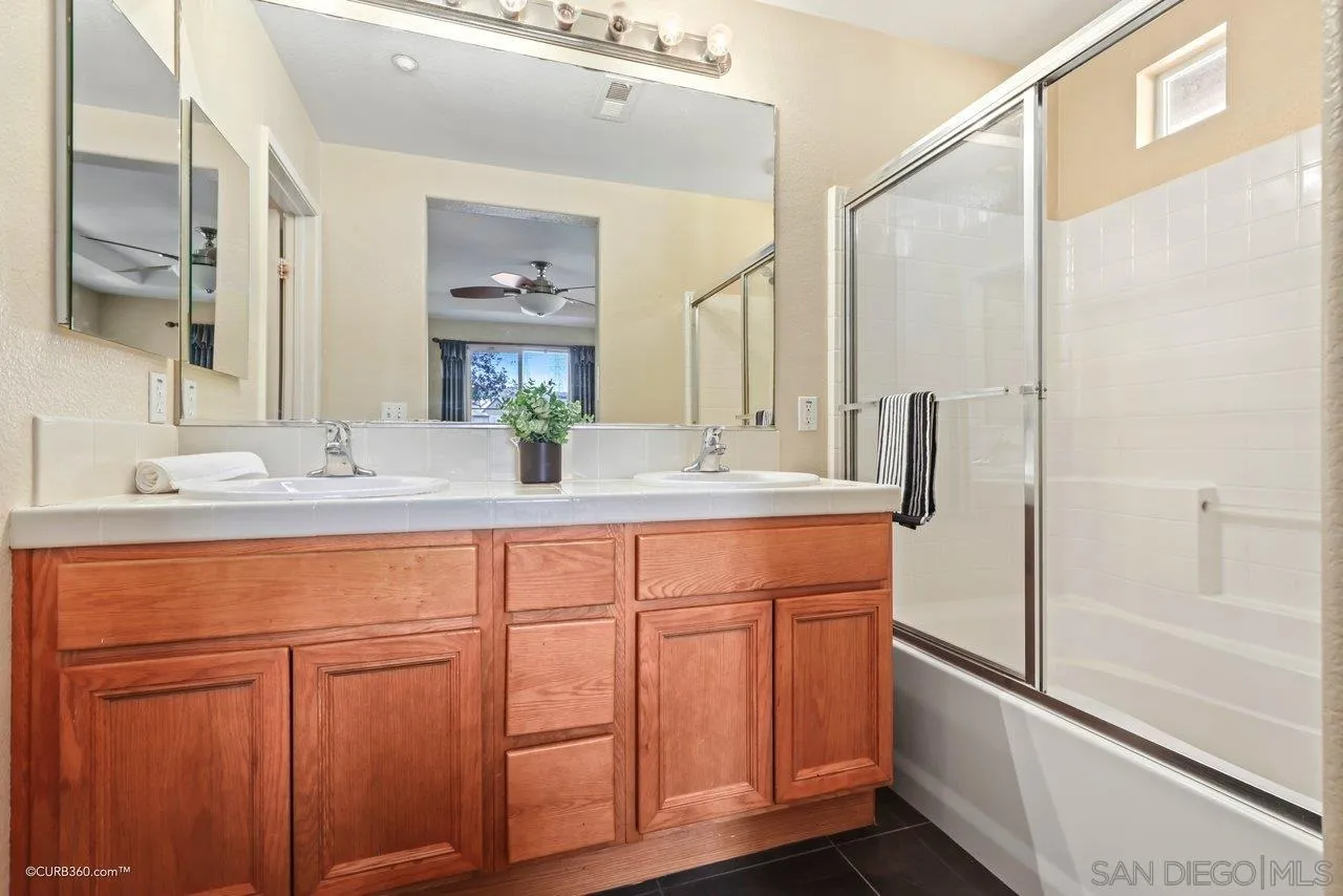 1685 Avery Road San Marcos, CA 92078 - Photo 17 of 26 a bathroom with a double vanity sink and a mirror