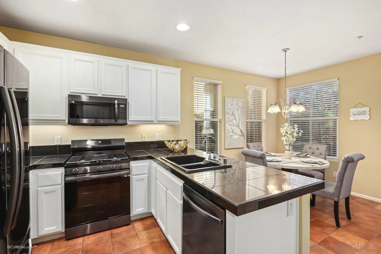 1685 Avery Road San Marcos, CA 92078 - Photo 10 of 26 a kitchen with granite countertop a stove sink and microwave