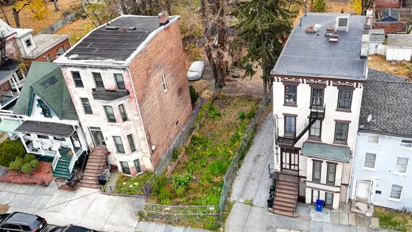 an aerial view of residential houses with street