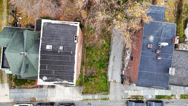a front view of a building with a yard