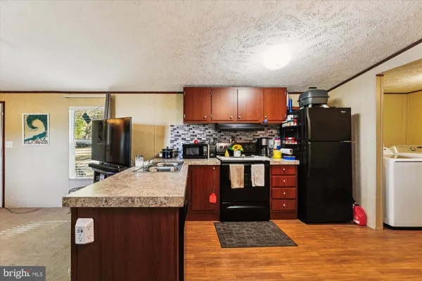 a kitchen with stainless steel appliances granite countertop a refrigerator and a stove