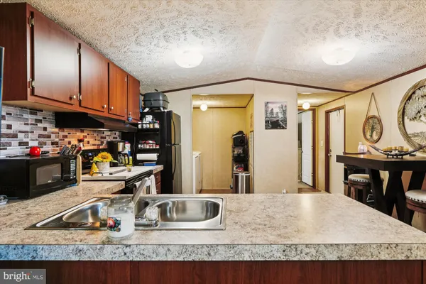 a kitchen with sink and refrigerator
