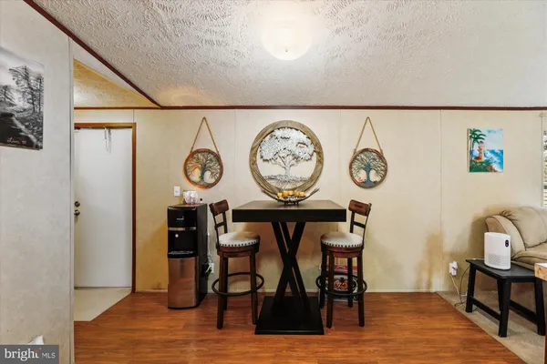 a view of a dining area with furniture and a clock