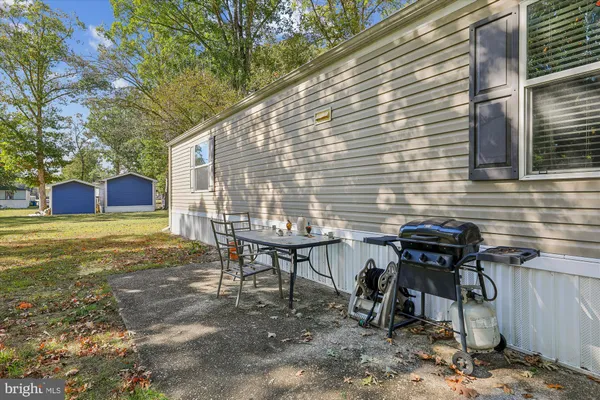 a view of a chairs and table in the backyard