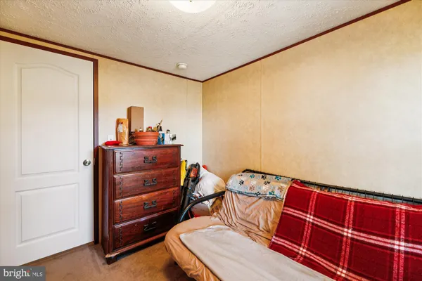 a view of a room with furniture and a window