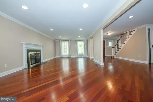 a view of empty room with wooden floor