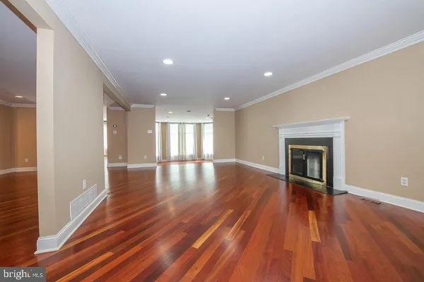 a view of a room with wooden floor and a fireplace