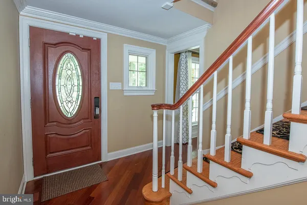 a view of entryway with wooden floor and door
