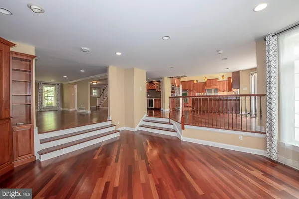 a view of front door with wooden floor and a floor to ceiling window