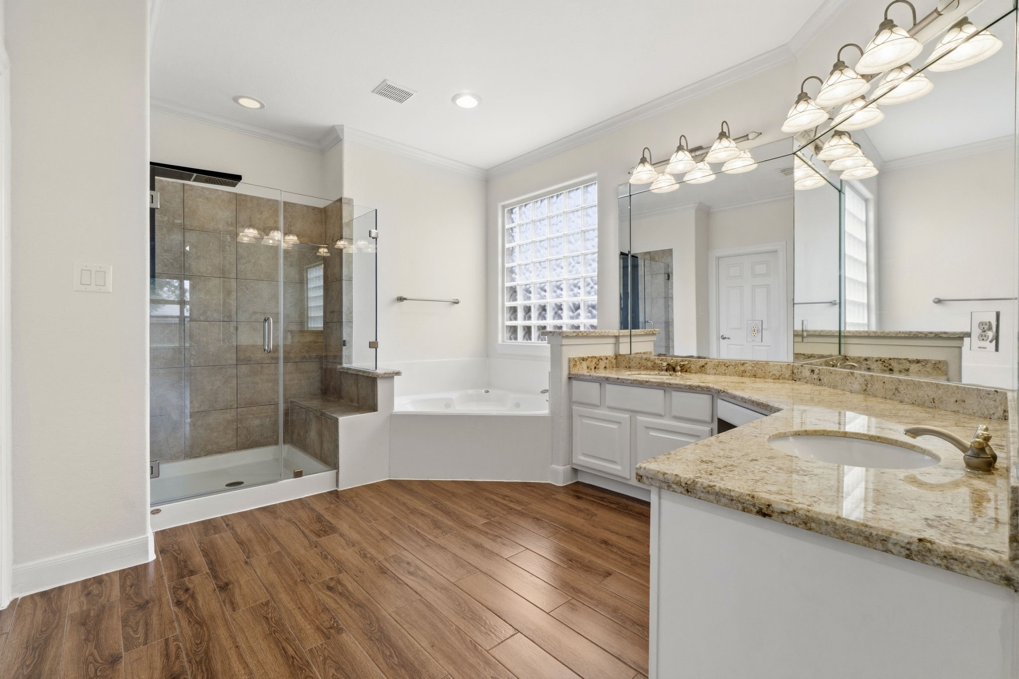 2716 Silverstone Way Conroe, TX 77304 - Photo 14 of 27 Featuring a remodeled shower, granite countertops with dual vanities and a soaking tub.