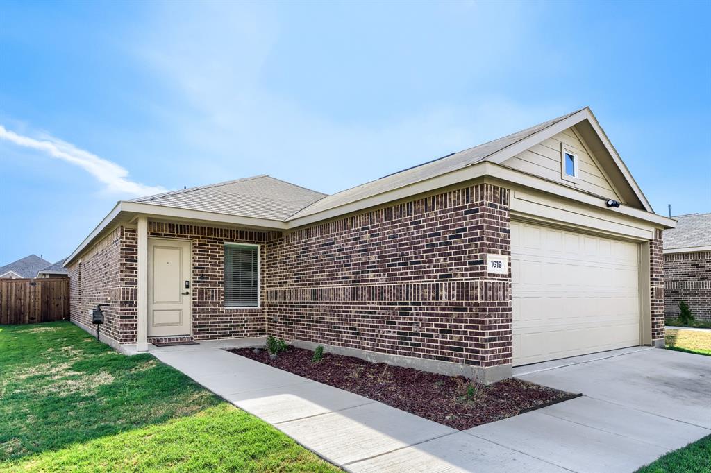 1619 Grassy Pond Road Forney, TX 75126 - Photo 6 of 28 Brick exterior with an attached garage, covered entryway, and a fenced side yard