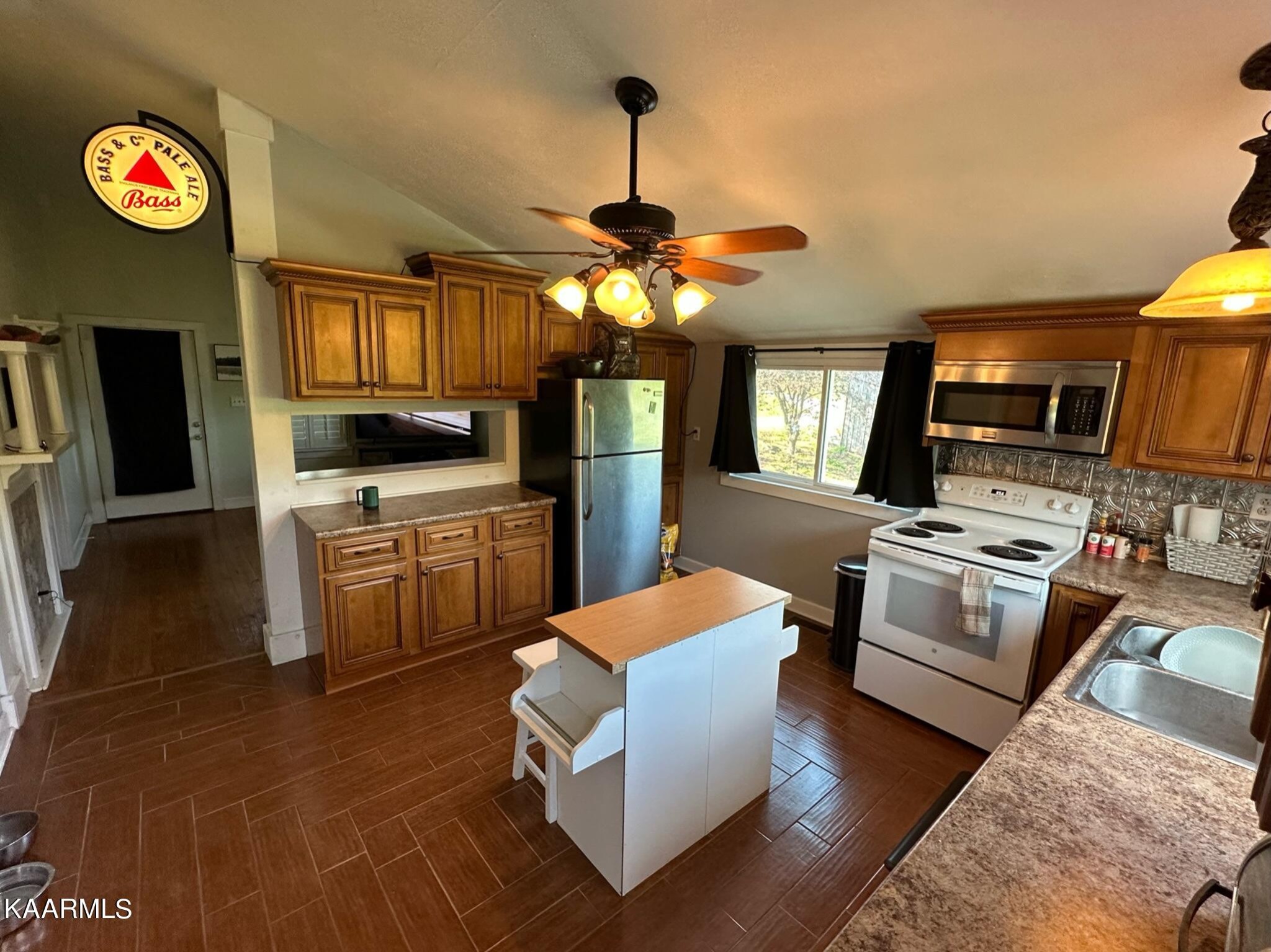 609 Bryan Road Rutledge, TN 37861 - Photo 28 of 47 a kitchen with stainless steel appliances granite countertop a stove top oven a sink dishwasher and a fireplace with wooden floor