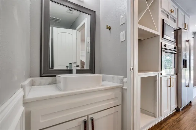 a bathroom with a shower sink and mirror