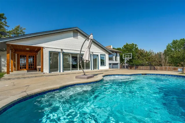 a view of a swimming pool with a patio