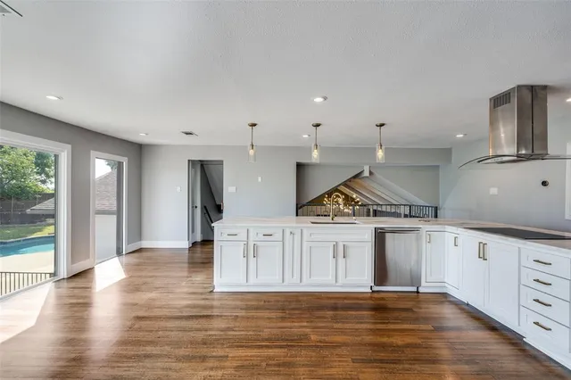 a view of a kitchen with sink wooden floor and windows
