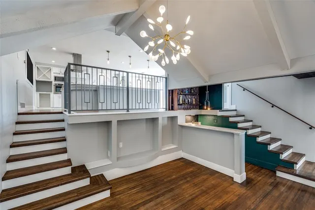 a view of a room with wooden floor and white walls