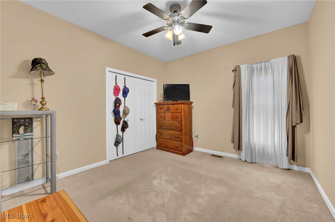 2690 Mayfair Road Akron, OH 44312 - Photo 22 of 31 Bedroom featuring light carpet, ceiling fan, and a closet
