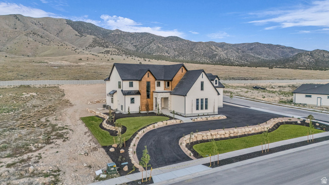 2828 Jojo Road Eagle Mountain, UT 84005 - Photo 58 of 63 Contemporary residence with a dark shingle roof, light-toned exterior siding, and natural wood accents