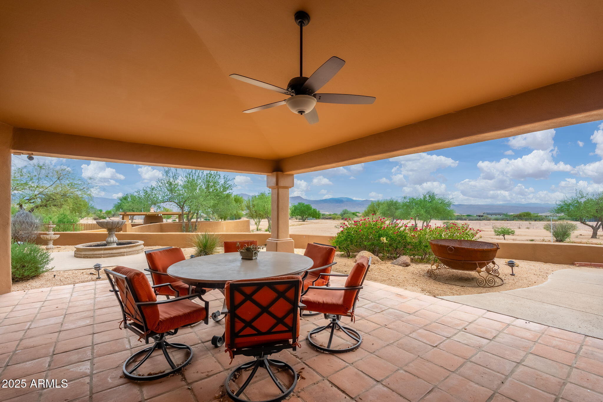 17047 East Dixileta Drive Rio Verde, AZ 85263 - Photo 14 of 115 a view of a patio with a dining table and chairs