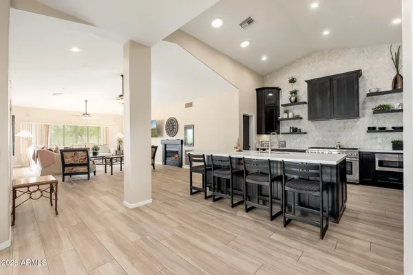 a bedroom with a large bed mirror and a window