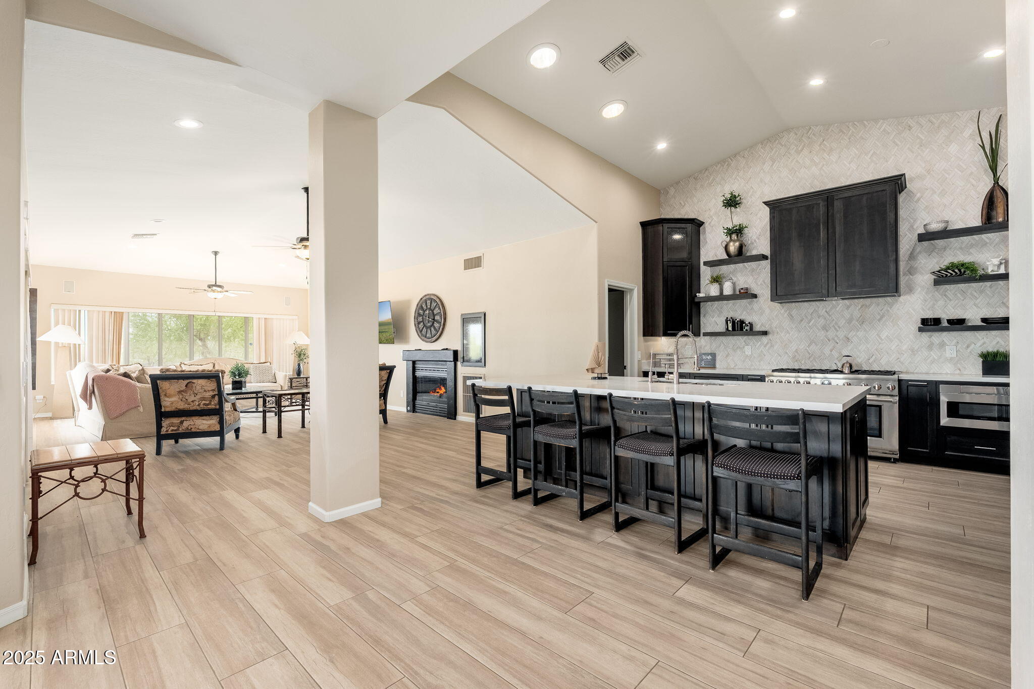 17047 East Dixileta Drive Rio Verde, AZ 85263 - Photo 32 of 115 a open kitchen with stainless steel appliances kitchen island granite countertop a table chairs sink and cabinets