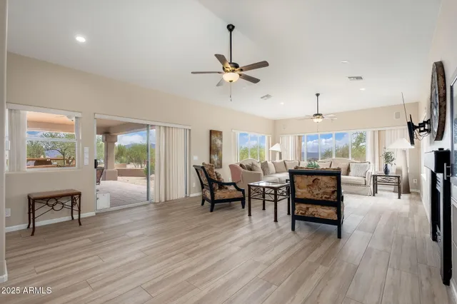 a living room with patio furniture and a floor to ceiling window