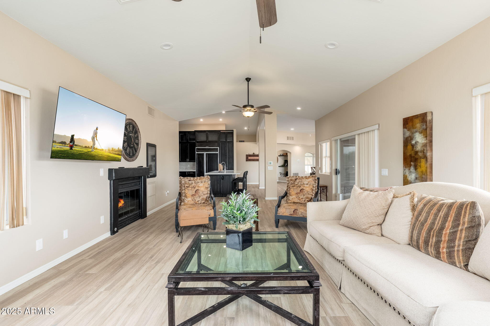 17047 East Dixileta Drive Rio Verde, AZ 85263 - Photo 41 of 115 a living room with furniture a fireplace and a flat screen tv