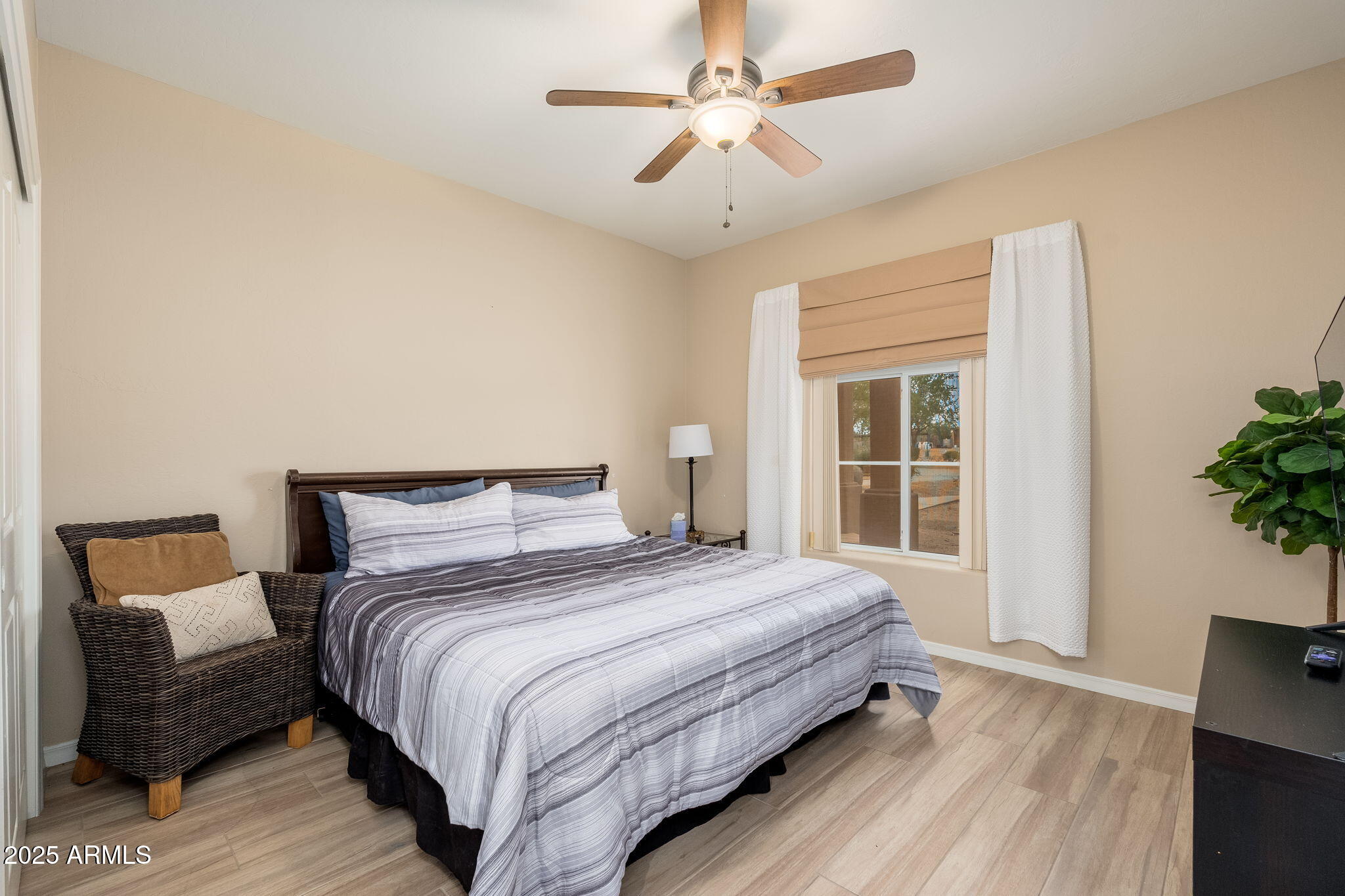 17047 East Dixileta Drive Rio Verde, AZ 85263 - Photo 57 of 115 a bedroom with a large bed mirror and a window