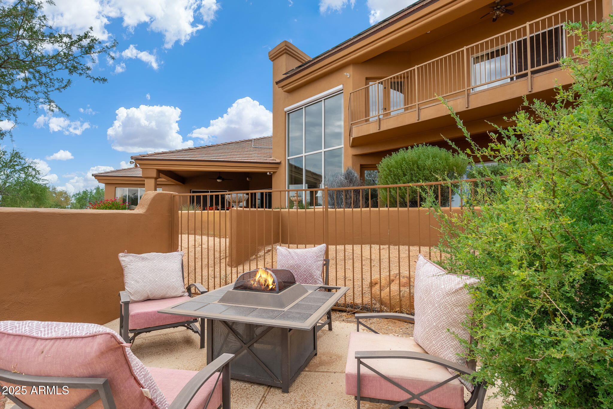 17047 East Dixileta Drive Rio Verde, AZ 85263 - Photo 67 of 115 a view of a patio with a table and chairs and potted plants