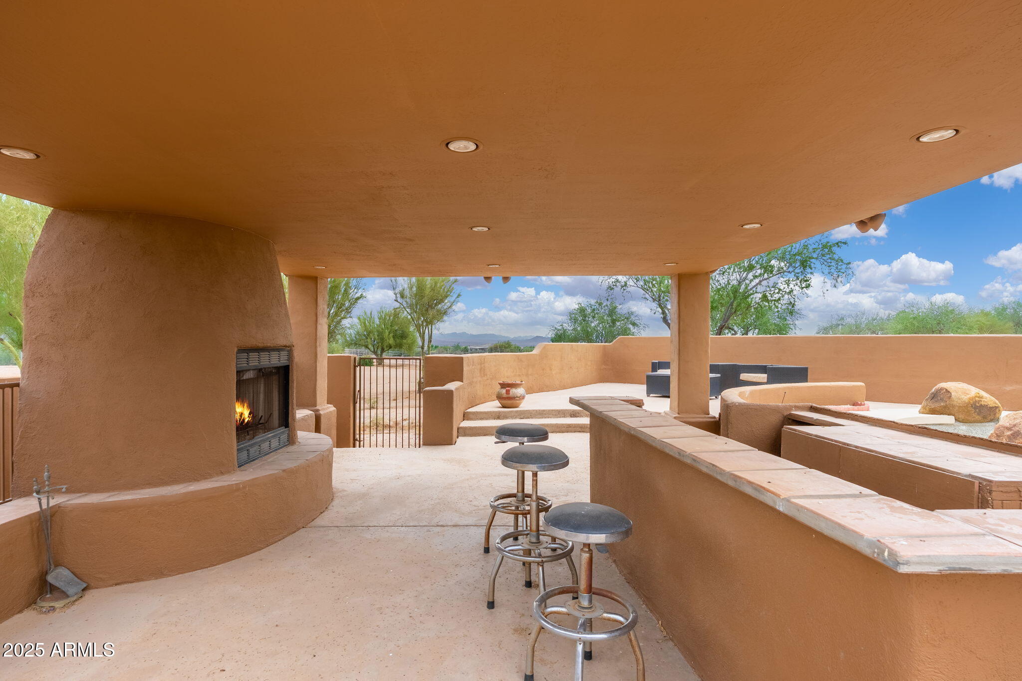 17047 East Dixileta Drive Rio Verde, AZ 85263 - Photo 71 of 115 a living room with patio furniture and a floor to ceiling window
