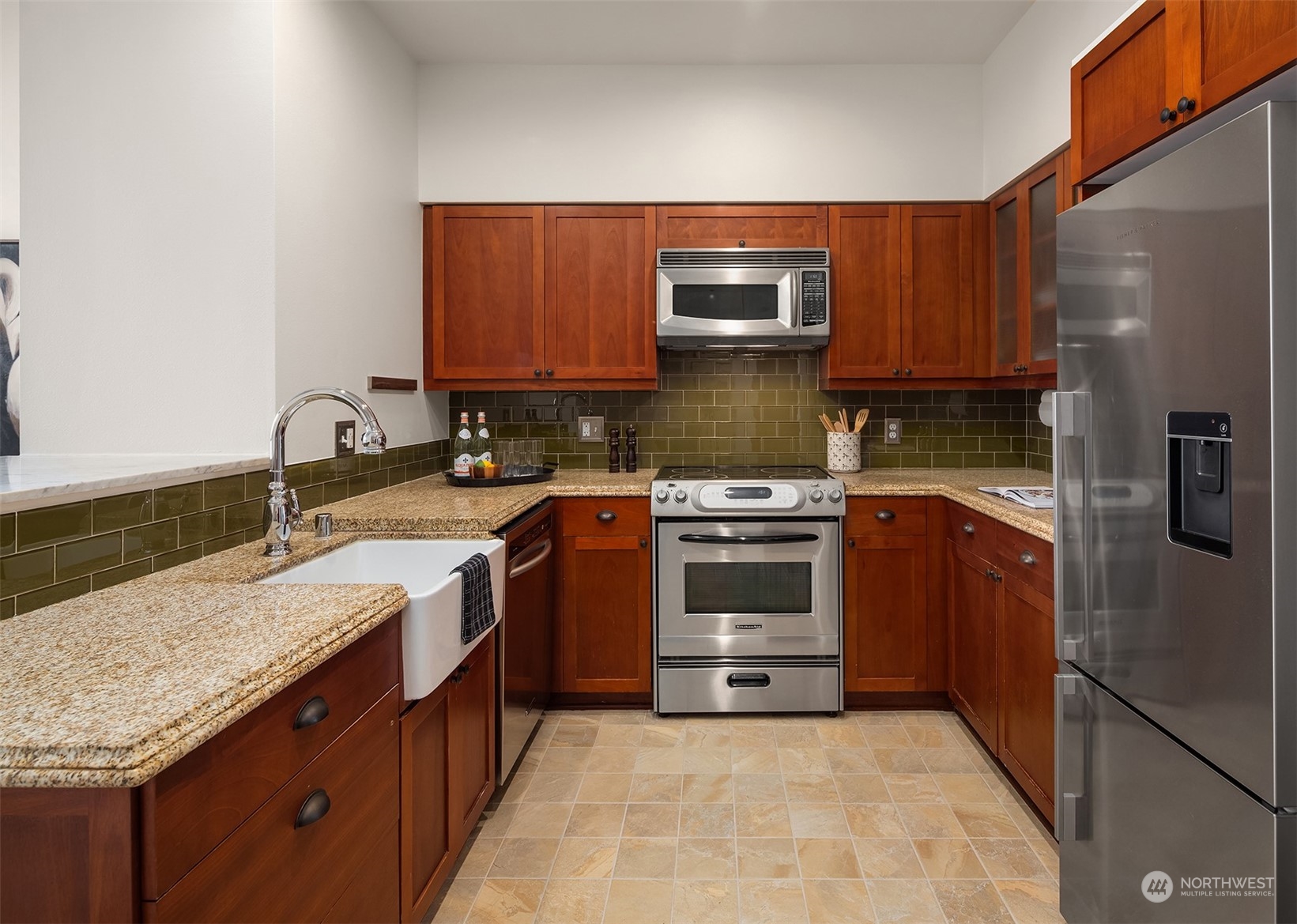 201 Galer Street, Unit 412 Seattle, WA 98109 - Photo 11 of 34 a kitchen with stainless steel appliances granite countertop a stove a sink and a microwave