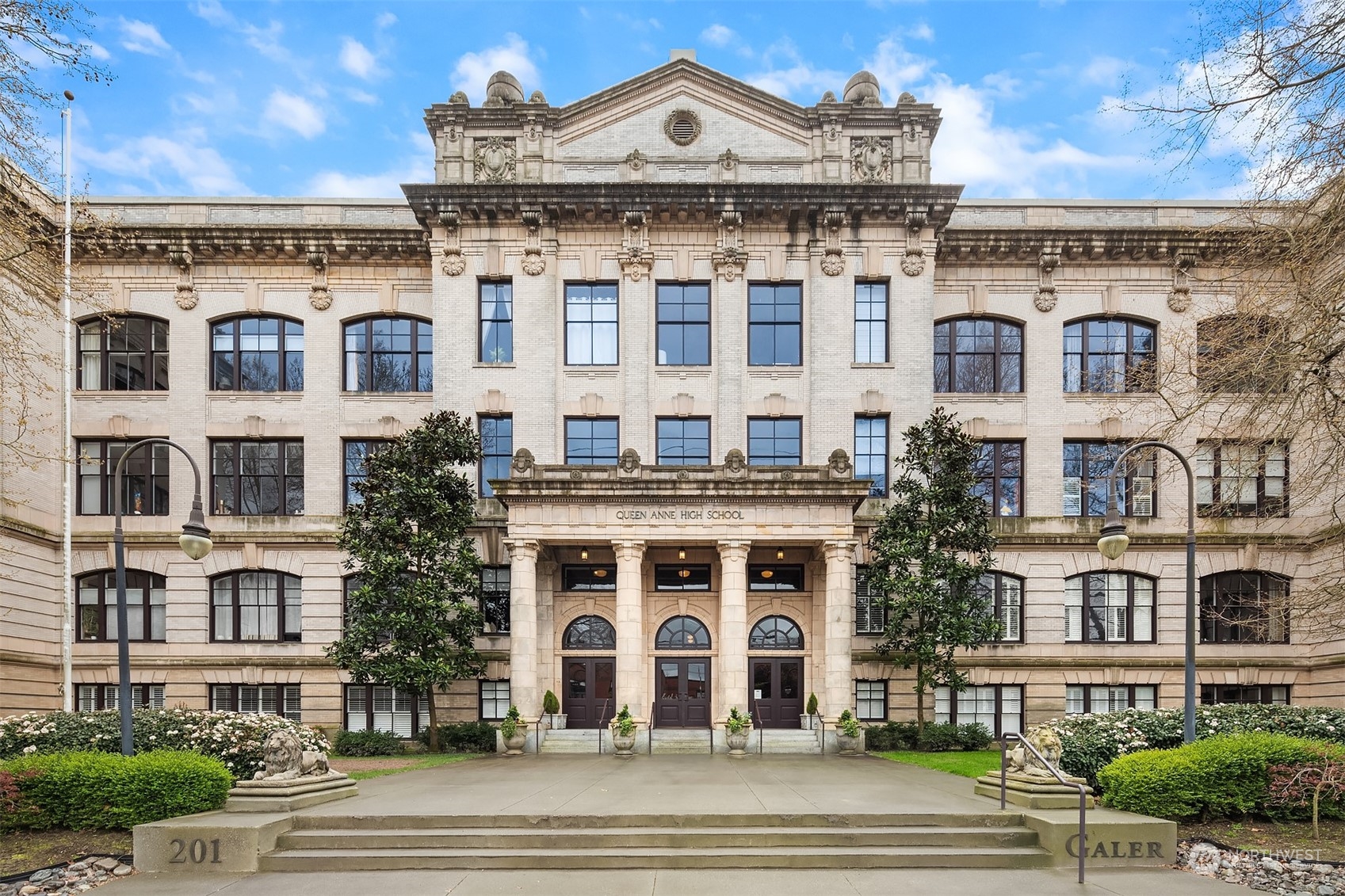 201 Galer Street, Unit 412 Seattle, WA 98109 - Photo 2 of 34 a view of a large building with a clock and a yard