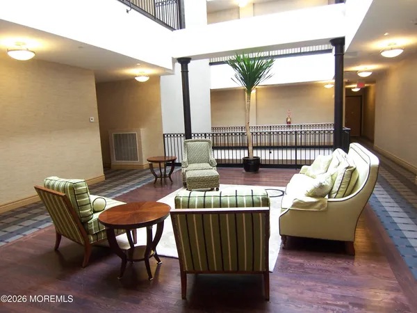 a view of a dining room with furniture and a potted plant