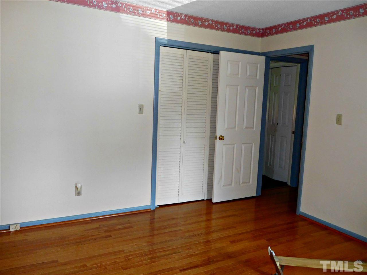 2217 Timberlake Drive Raleigh, NC 27604 - Photo 14 of 22 an empty room with wooden floor