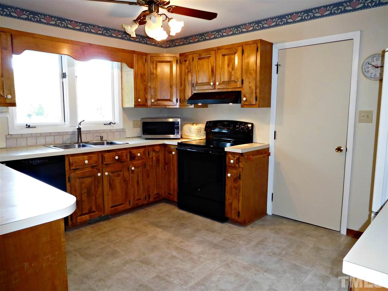 2217 Timberlake Drive Raleigh, NC 27604 - Photo 4 of 22 a kitchen with stainless steel appliances granite countertop a stove a sink and a microwave