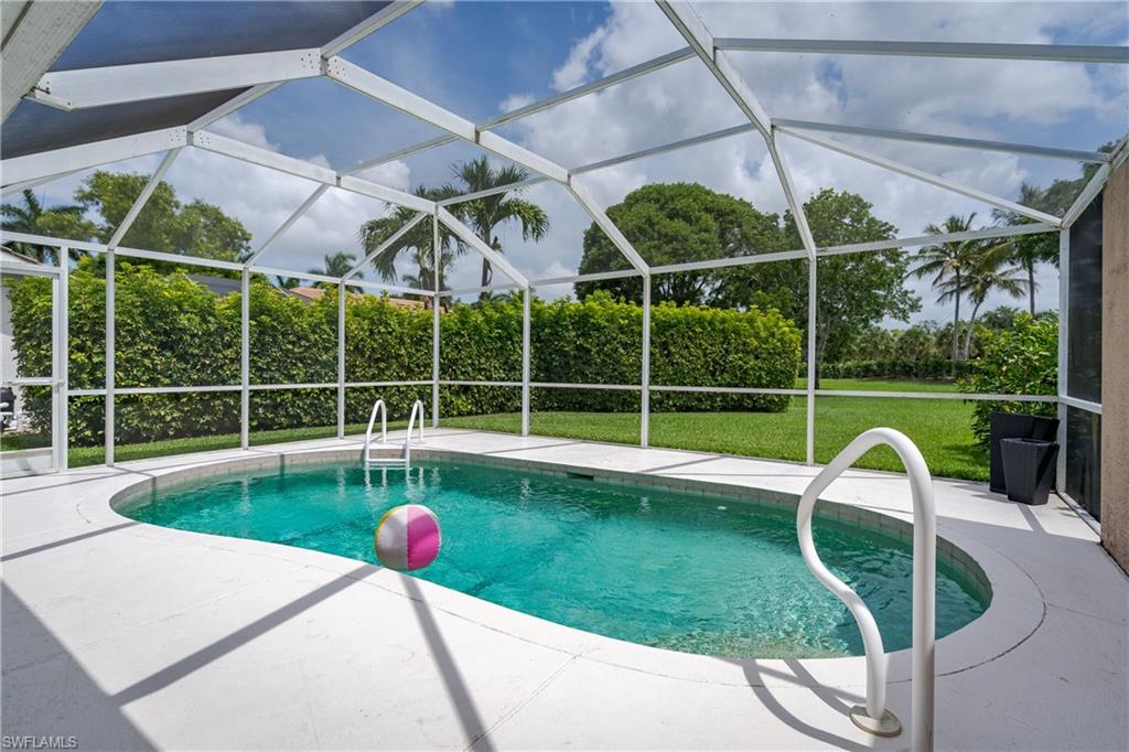 6658 Castlelawn Place, Unit 9 Naples, FL 34113 - Photo 29 of 38 Screened-in outdoor pool featuring a curved design and white deck surround