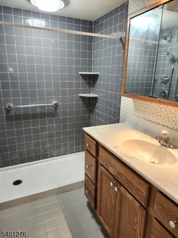 a bathroom with a granite countertop sink a toilet and bathtub