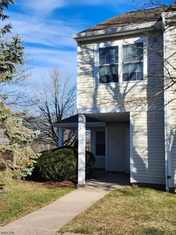 a view of house with backyard space and balcony