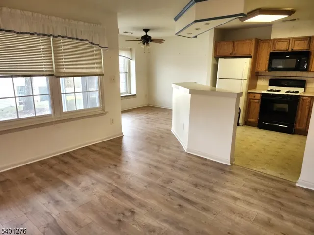 a view of a kitchen with a stove cabinets and wooden floor