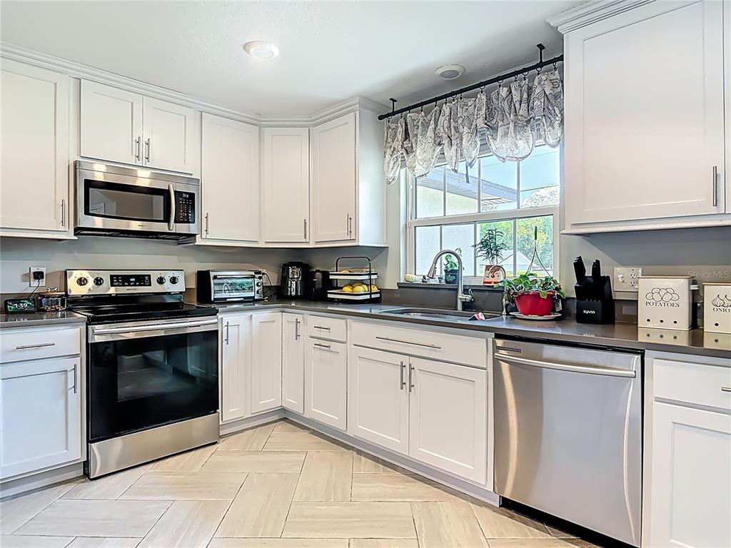108 Palmira Road DeBary, FL 32713 - Photo 11 of 29 a kitchen with stainless steel appliances granite countertop a sink a stove and cabinets