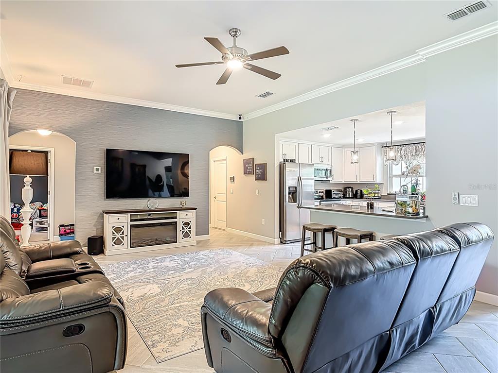 108 Palmira Road DeBary, FL 32713 - Photo 13 of 29 a living room with furniture kitchen view and a flat screen tv
