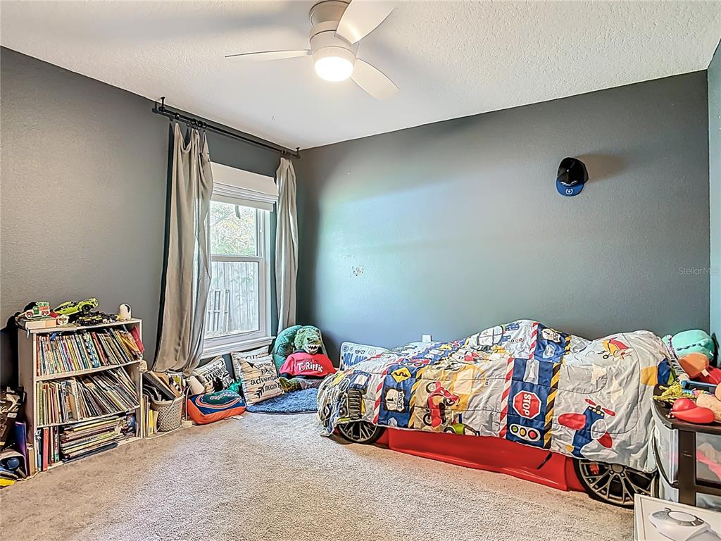 108 Palmira Road DeBary, FL 32713 - Photo 19 of 29 a bedroom with a bed and a chandelier