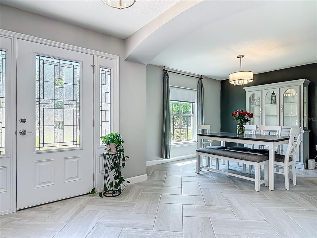 108 Palmira Road DeBary, FL 32713 - Photo 4 of 29 a living room with furniture a chandelier and a window