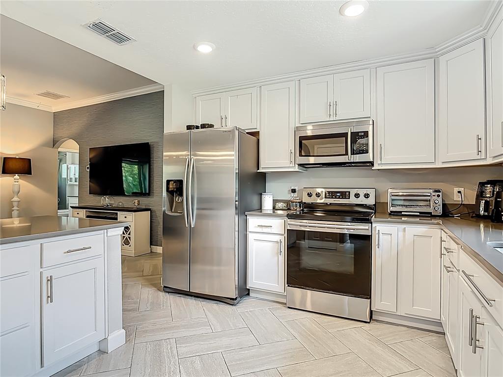 108 Palmira Road DeBary, FL 32713 - Photo 6 of 29 a kitchen with cabinets stainless steel appliances and a counter space