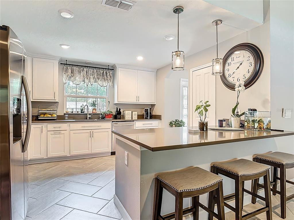 108 Palmira Road DeBary, FL 32713 - Photo 7 of 29 a kitchen with a sink cabinets and stainless steel appliances