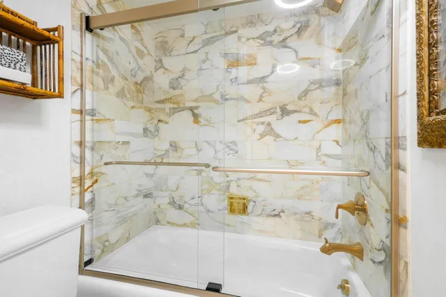 a bathroom with a bathtub and shower