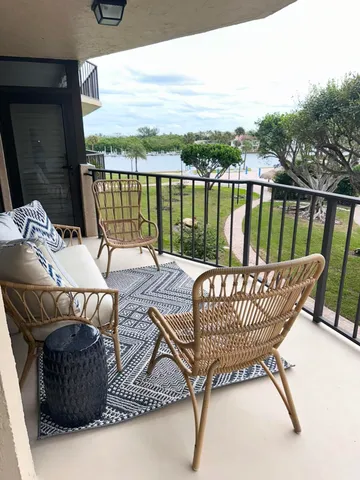 a roof deck with couches and wooden floor